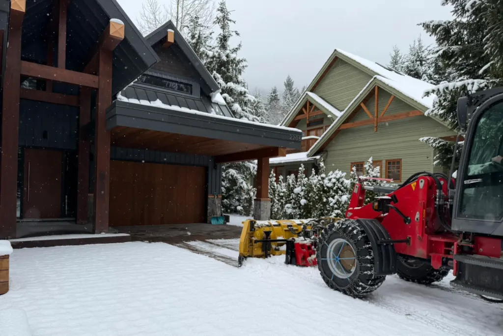 tractor clearing snow from a driveway in Whistler